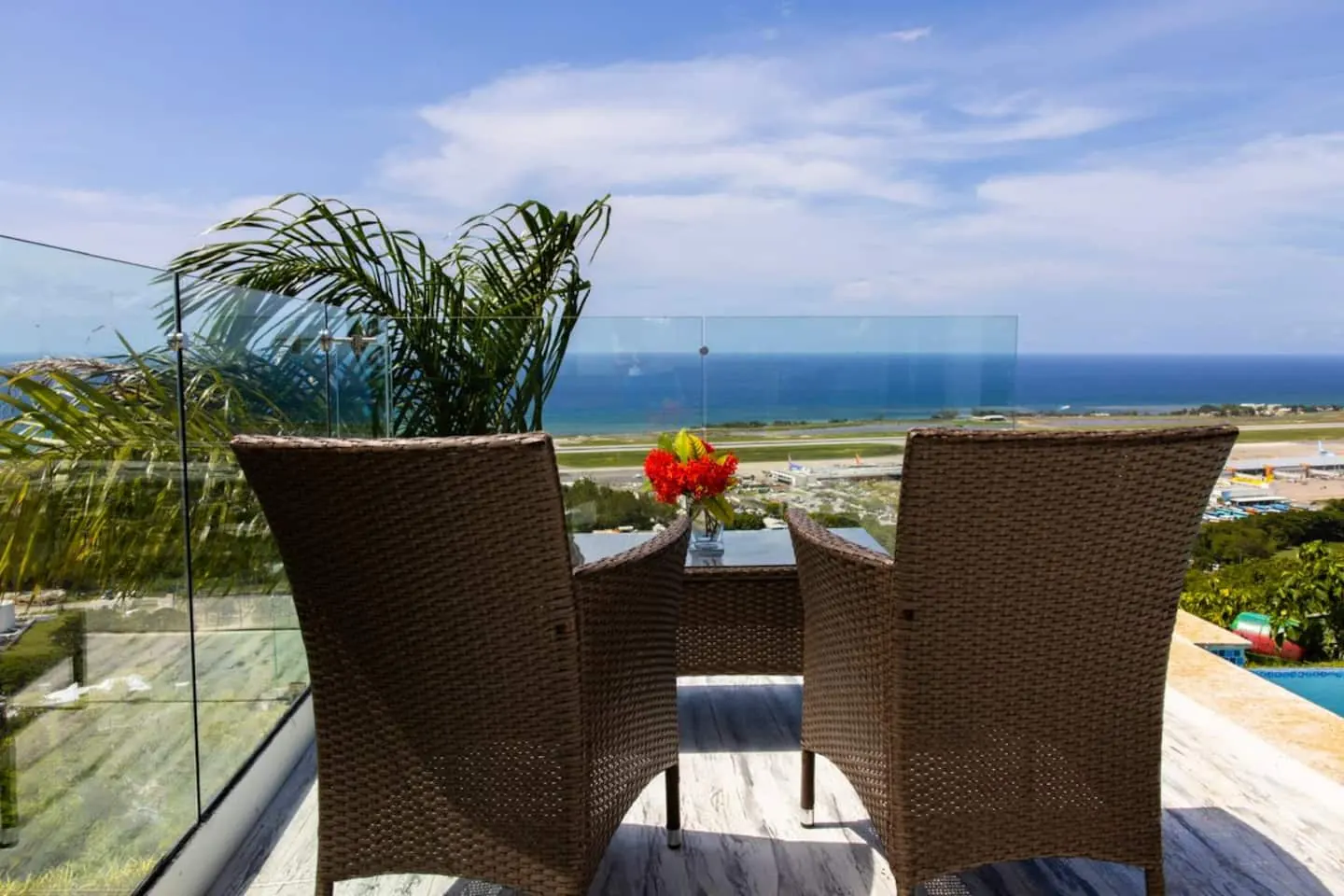Outdoor seating with views across Montego Bay airport to the sea.