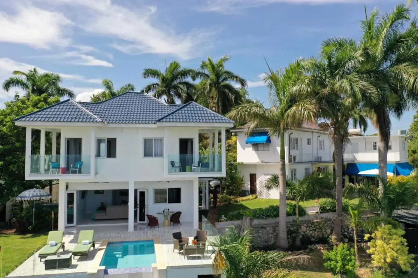 Glory from outside: two storeys, bedroom balconies and a pool terrace.
